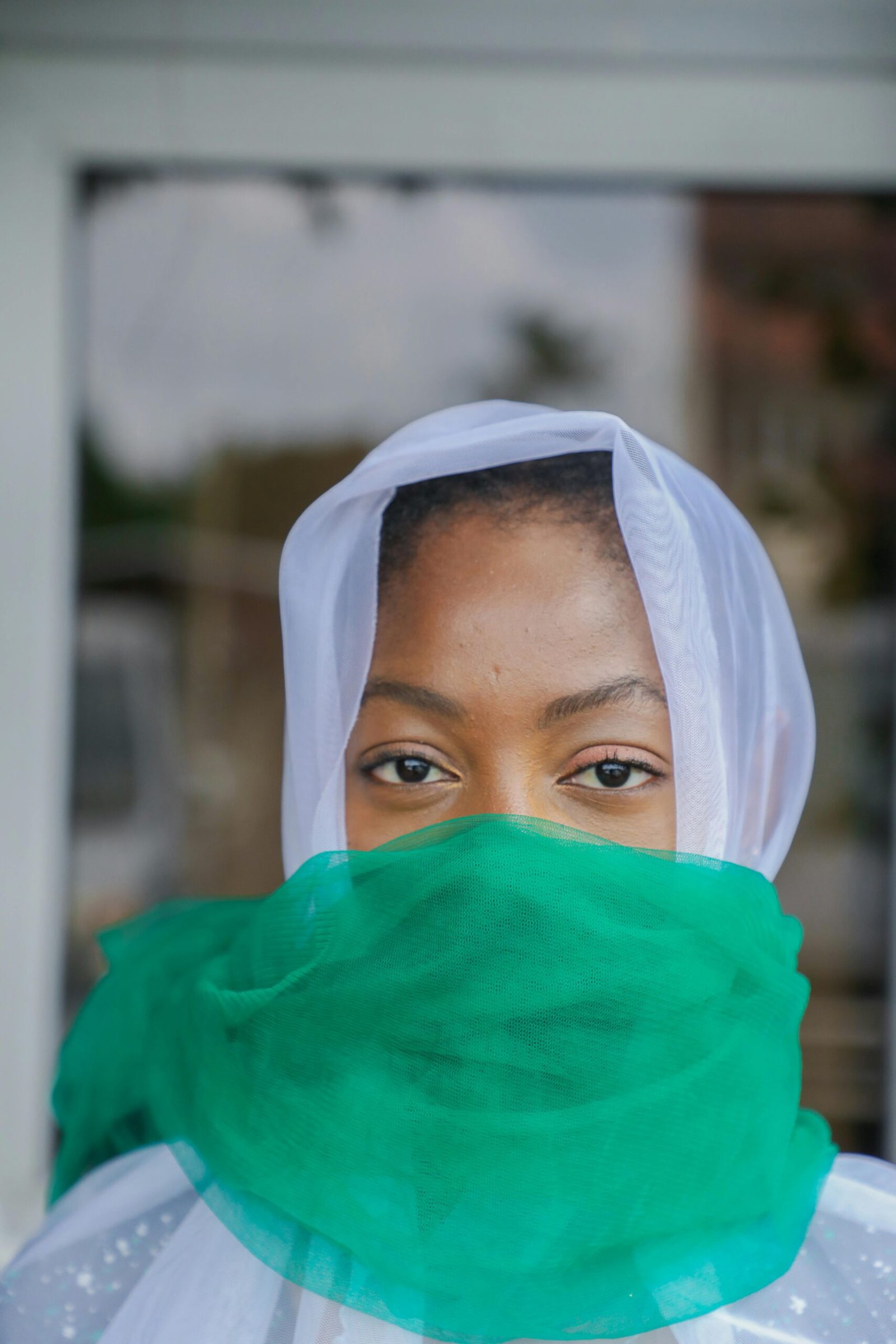 Portrait of Nigerian woman in green and white headscarf