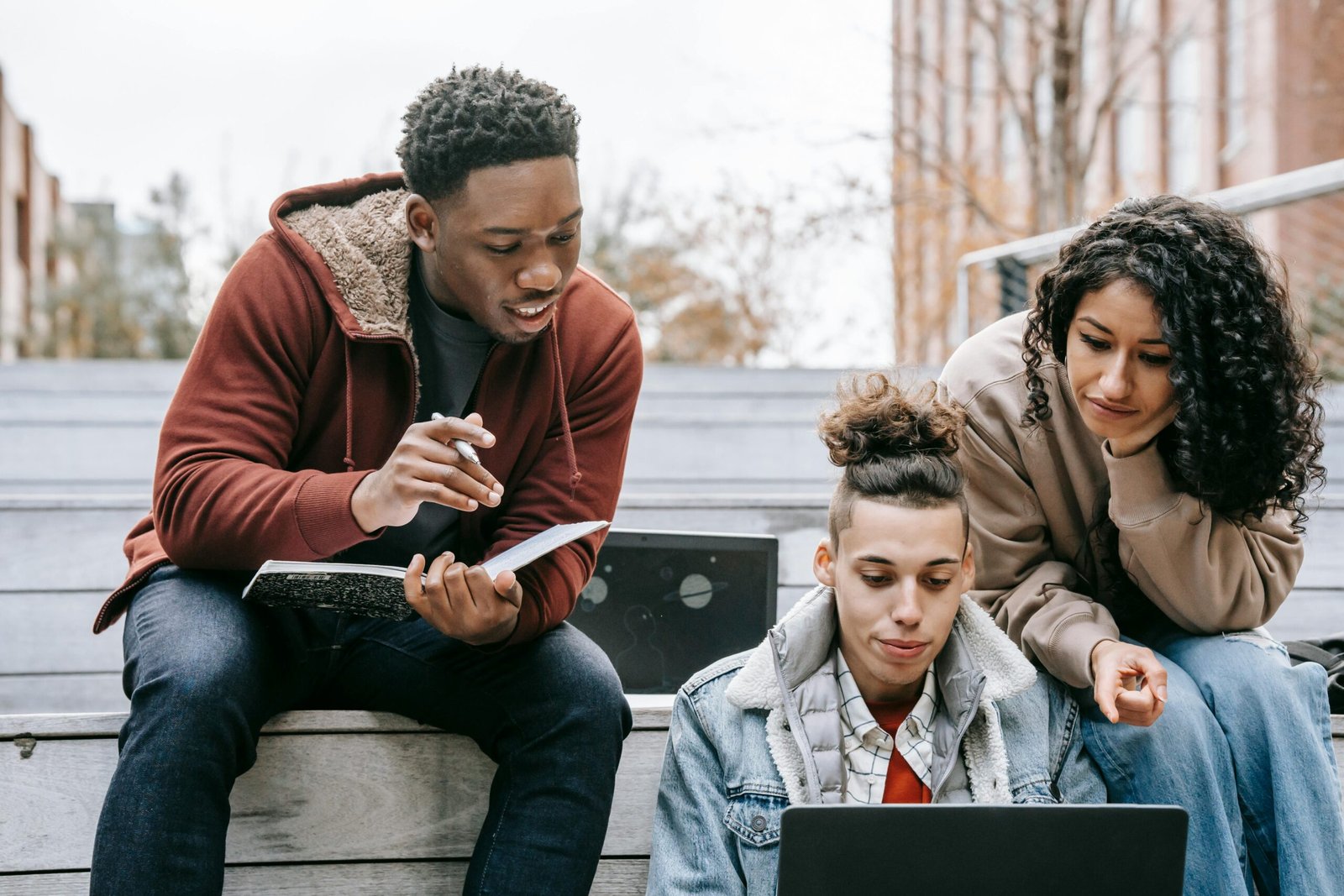 Group of friends researching on a laptop