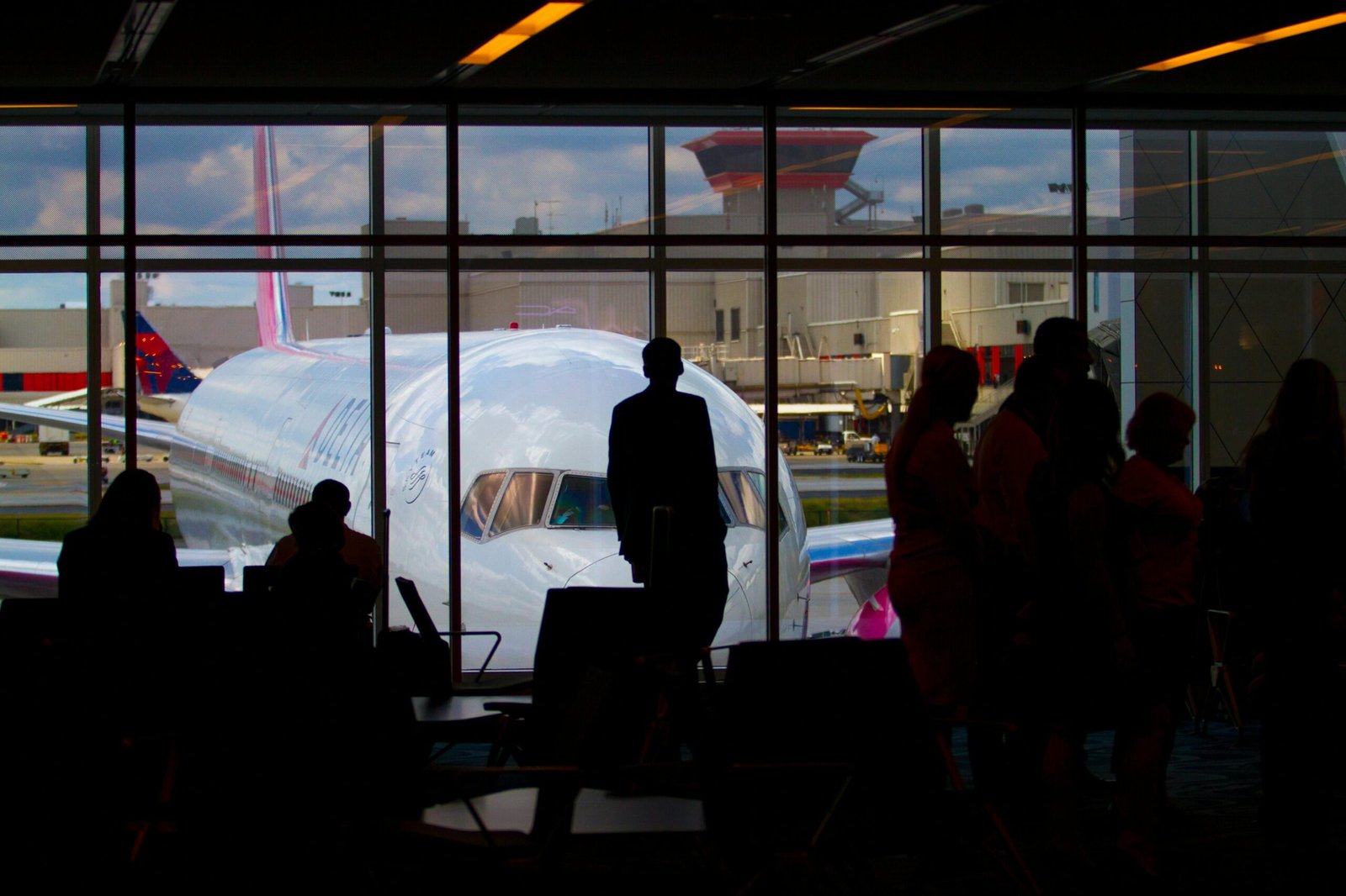 Silhouettes of People Near an Airplane