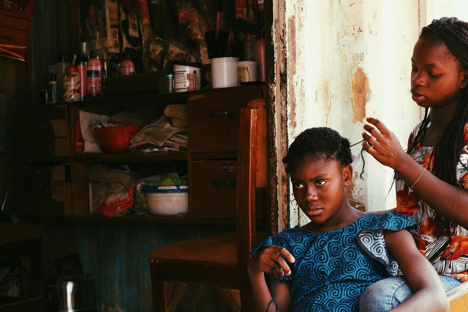 A Nigerian Mother Making her Daughter's Hair