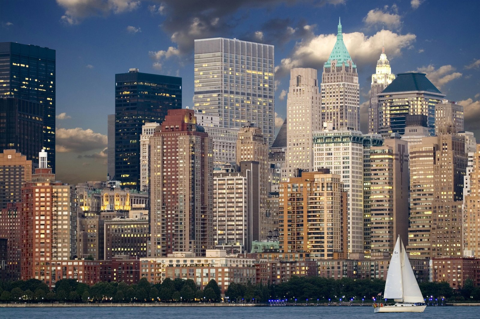Cityscape during Nighttime Near Body of Water and Sail Boat in New York City, United States